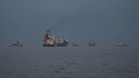 Oil tankers and cargo ships line up in the Strait of Hormuz as seen from Khor Fakkan, United Arab Emirates