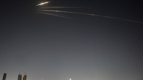 Missiles launched from Iran streak across the sky over central Israel