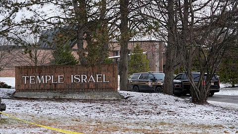 Police vehicles sit outside the Temple Israel synagogue in West Bloomfield Township, Mich.