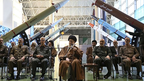 In this photo released by an official website of the office of the Iranian supreme leader, Supreme Leader Ayatollah Ali Khamenei, center, accompanied by the armed forces commanders, visits an exhibition of the Revolutionary Guard's aerospace achievements, in Iran, Nov. 19, 2023.