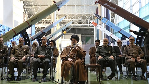 In this photo released by an official website of the office of the Iranian supreme leader, Supreme Leader Ayatollah Ali Khamenei, center, accompanied by the armed forces commanders, visits an exhibition of the Revolutionary Guard's aerospace achievements, in Iran