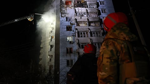 Rescue workers try to put out a fire of a residential building burning after a Russian drone attack on Zaporizhzhia, Ukraine, Tuesday, March 24, 2026.