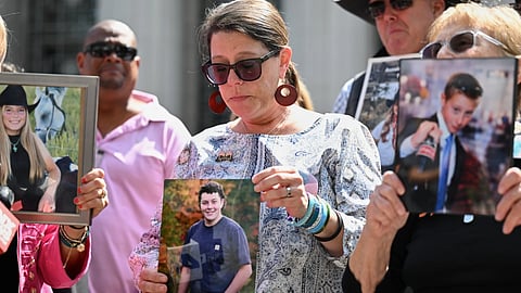 Mary Rodee holds a photo of her son Riley after the verdict in a landmark trial over whether social media platforms deliberately addict and harm children at Los Angeles Superior Court