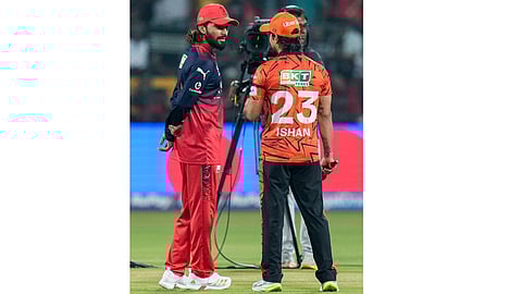 Royal Challengers Bengaluru's captain Rajat Patidar, left, and Sunrisers Hyderabad's captain Ishan Kishan during the toss before an Indian Premier League (IPL) 2026 T20 cricket match between Royal Challengers Bengaluru and Sunrisers Hyderabad, at the M Chinnaswamy Stadium, in Bengaluru, Karnataka, Saturday, March 28, 2026