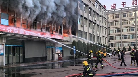 Firefighters containing fire in a building near Qinxian North Street in Taiyuan located in North China's Shanxi Province