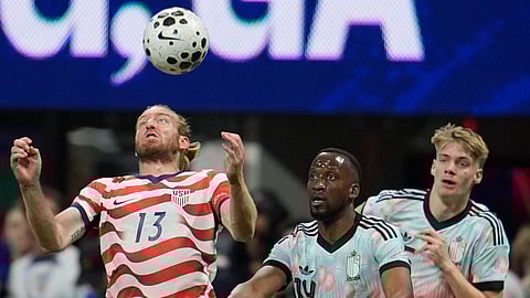 United States' Tim Ream (13) tries the control the ball as Belgium's Dodi Lukebakio (14) looks on during the second half of an international friendly soccer match, Saturday, March 28, 2026, in Atlanta