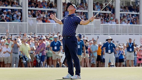 Gary Woodland celebrates after sinking his final putt on the 18th green to win the Texas Children's Houston Open golf tournament
in Houston.