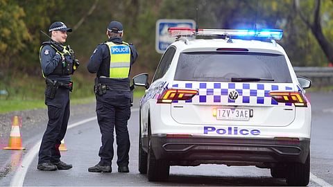 Police man a road block in Porepunkah, in the state of Victoria, Australia