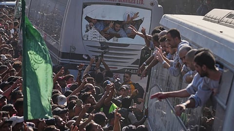 People gather to greet freed Palestinian prisoners arriving on buses in the Gaza Strip after their release from Israeli jails under a ceasefire agreement between Hamas and Israel, outside Nasser Hospital in Khan Younis, southern Gaza Strip