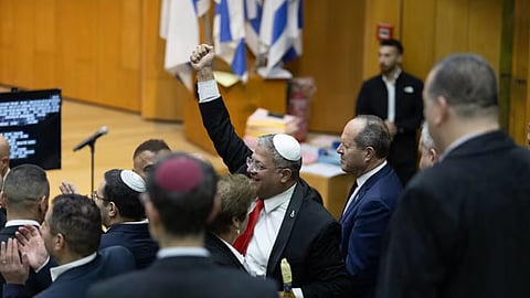 Israel's Minister of National Security, Itamar Ben-Gvir, center, and lawmakers celebrate after Israel's parliament passed a law approving the death penalty for Palestinians convicted of murdering Israelis