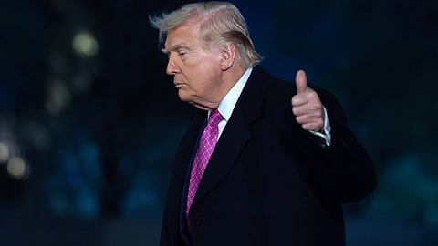 President Donald Trump waves to the media as he walks on the South Lawn upon his arrival to the White House