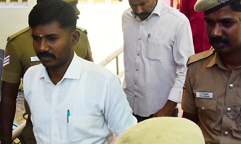 Convicts being brought to the Madurai district court under police escort on Thursday