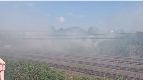 Smoke billows from burning garbage dump adjacent to railway track between Chromepet and Santorium