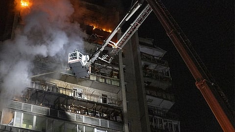 In this photo provided by the Ukrainian Emergency Services on Saturday, April 4, 2026, rescue workers put out a fire of a residential building damaged following a Russian strike in Sumy, Ukraine.