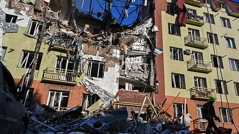 A rescue worker walks in front of residential building which was heavily damaged after a Russian strike in Odesa, Ukraine