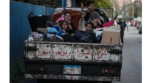 Displaced children sit on a truck with their packed belongings as they wait for an official ceasefire decision between Iran and the United States that they hope will include Lebanon and allow them to return to their villages, in the southern port city of Sidon, Lebanon, Wednesday, April 8, 2026