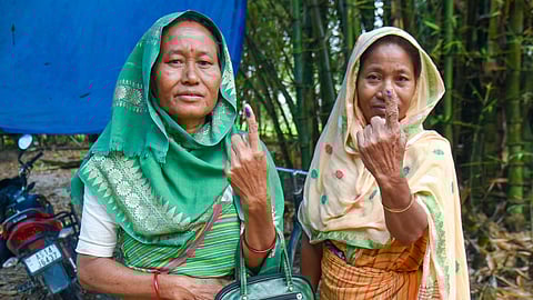 A woman shows her ink-marked finger after casting a vote in the Assam Assembly elections, at a polling station in Nagaon, Thursday, April 9, 2026