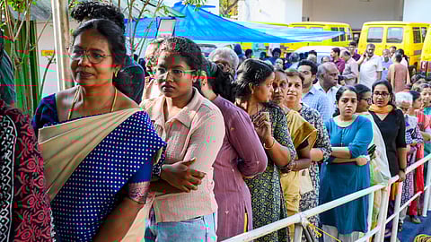 People wait in a queue to cast votes during the Kerala Assembly elections, at a polling station, in Thiruvananthapuram, Thursday, April 9, 2026