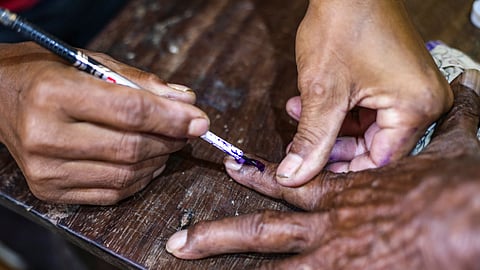 A voter gets his finger marked before casting a vote in the by-election