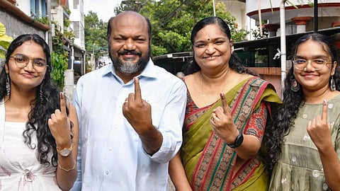 LDF candidate P Rajeev, second left, and his family members show their ink-marked fingers after casting votes during the Kerala Assembly elections, in Ernakulam district, Thursday, April 9, 2026
