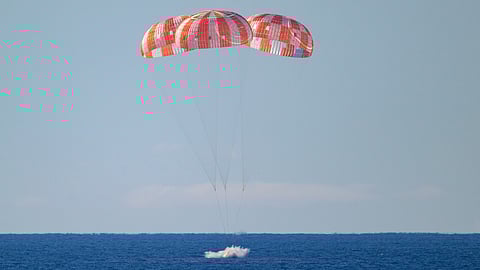 The Orion spacecraft with Artemis II crewmembers aboard splashes down in the Pacific Ocean off the coast of California