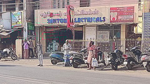 People waiting in the open near the Chembiam Old Post Office