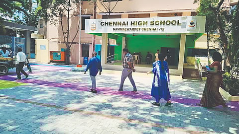 Pathways marked in blue and pink at the polling station in Chennai High School in Nammalwarpet