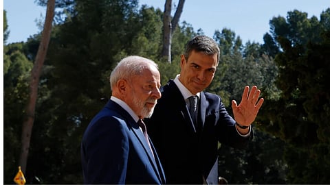 Spain's Prime Minister Pedro Sanchez, right, waves next to Brazil's President Luiz Inacio Lula da Silva during a Spain-Brazil summit in Barcelona, Spain