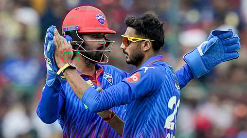 Delhi Capitals' captain Axar Patel, right, celebrates with teammate KL Rahul after dismissing Royal Challengers Bengaluru's Tim David during the Indian Premier League (IPL) 2026 T20 cricket match between Royal Challengers Bengaluru and Delhi Capitals