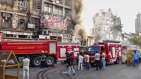 Fire personnel attempt to douse a blaze that broke out in shops near Crawford Market, in Mumbai, Maharashtra, Sunday, April 19, 2026