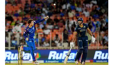 Gujarat Titans' Shahrukh Khan, right, looks on as Mumbai Indians' Mitchell Santner bowls during the Indian Premier League (IPL) 2026 T20 cricket match between Gujarat Titans and Mumbai Indians, in Ahmedabad, Monday, April 20, 2026