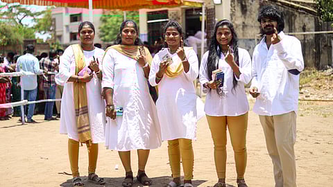 A group of youngsters in TVK's signature attire at a booth in Pulianthope