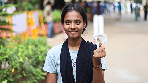 A first-time voter is thrilled after getting inked