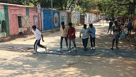 People using broken footpath at Triplicane railway station