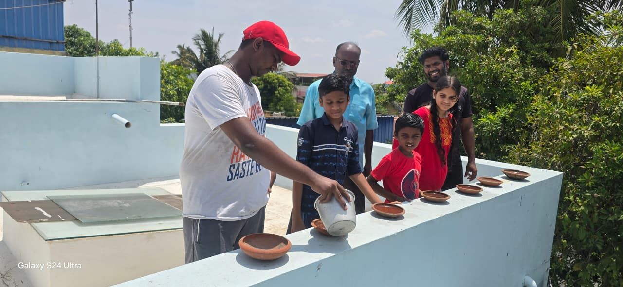 Residents filling water in clay basins for birds in Tiruchy on Tuesday