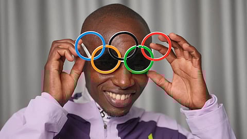 Kenya's Sabastian Sawe poses with Olympic Ring sun-glasses during an interview with The Associated Press after winning the London Marathon, in London
