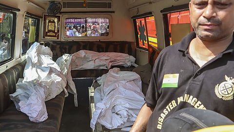Recovered bodies are being transferred in an ambulance after a fire in a four-storey residential building killed at least nine people, at Vivek Vihar area, in New Delhi