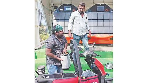 A man swapping batteries for electric two-wheeler at the new facility in Egmore railway station