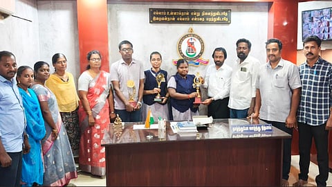 Secretary of Sambavika Higher Secondary School in Sivaganga felicitates third-ranked Akshaya and other achievers on Friday