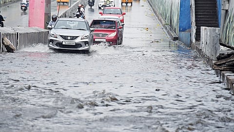 Motorists navigate stagnated Melapudur bridge in a risky manner in Tiruchy on Saturday