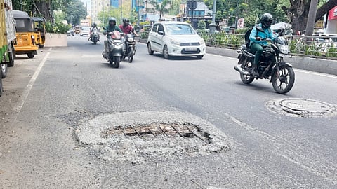 Neglected manhole cover with iron rods protruding on Sir Thyagaraya Road near Pondy Bazaar