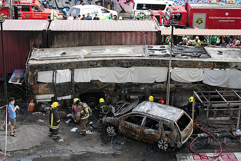 Rescuers work at a train crash site near an airport rail link station in Bangkok, Thailand, Saturday, May 16, 2026.