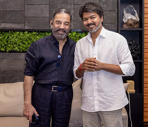 In this image posted on May 16, 2026, Tamil Nadu Chief Minister Vijay, right, being presented by a book from actor Kamal Hassan.