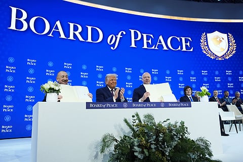 President Donald Trump, center, applauds as Ilham Aliyev, President of Azerbaijan, left, and Bulgaria’s Prime Minister Rossen Jeliazkov, right, hold up their signed Board of Peace charter during the Annual Meeting of the World Economic Forum in Davos, Switzerland