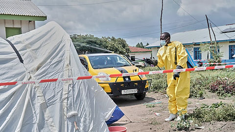 A man sprays a tent at an Ebola treatment center in Bunia