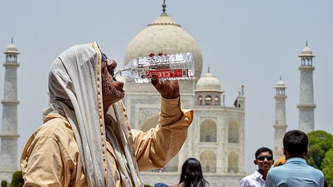 A man drinks water to quench his thirst amid scorching heat during the summer season, at Taj Mahal, in Agra, Uttar Pradesh, Saturday, May 23, 2026