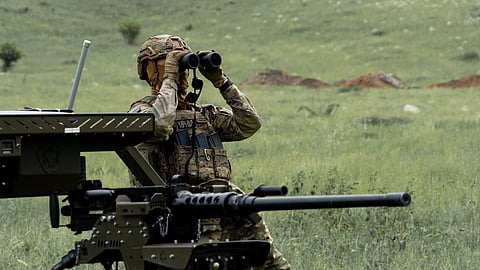 A Ukrainian serviceman of the Cerberus Ground Unmanned Systems Company of the 60th Separate Mechanized Brigade, Third Army Corps, conducts a drill with a combat ground drone during a training at the polygon in Kharkiv region, Ukraine, Sunday, May 24, 2026.