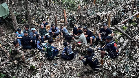 In this image released by Metta Tham Rescue Kalasin, rescuers try to reach people who have been trapped in a cave in Xaisomboun province, Laos, Tuesday, May 26, 2026.