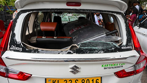 A damaged vehicle which was carrying Enforcement Directorate (ED) officials is seen after Left Democratic Front (LDF) activists allegedly attacked it outside former Kerala chief minister Pinarayi Vijayan's residence following a raid conducted as part of the ED's investigation into the CMRL money laundering case, in Thiruvananthapuram, Kerala, Wednesday, May 27, 2026