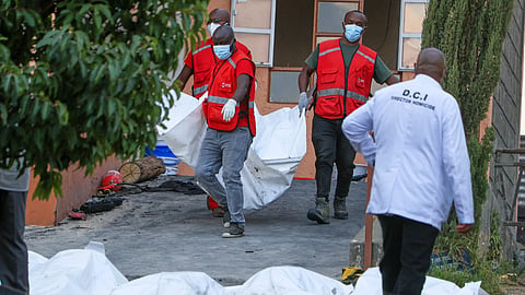 Red Cross members recover the bodies of students who died in the re at the Utumishi Girls School in the Gilgil area, central Kenya, Thursday, May 28, 2026.